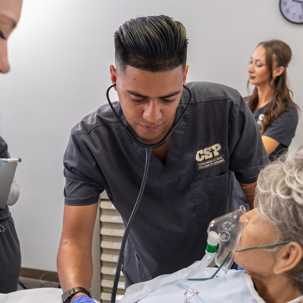 Group of nursing students working in a lab setting.